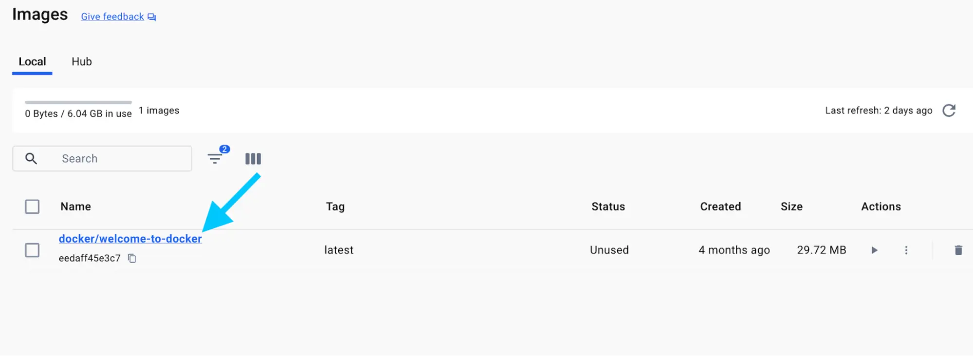 A screenshot of the Docker Dashboard showing the images view with an arrow pointing to the docker/welcome-to-docker image